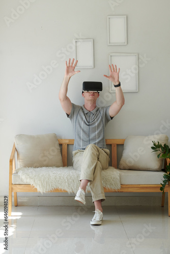 Young developer testing virtual reality simulator at home