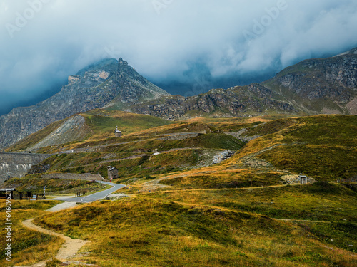 View of the hills and mountains under cloudy sky in Gran Paradiso National Park, Italy.