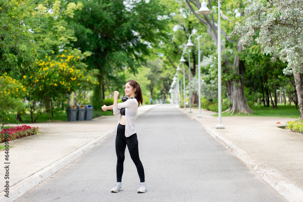 Young woman exercising and stretching in the park. Female Jogging and Doing Fitness Exercises in the City Park. Young woman exercising and stretching in the park. Female Jogging and Doing Fitness Exercises in the City Park.
