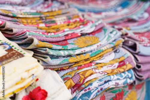 Multi-colored towels on the counter of a trade tent at a fair. © Dzmitry