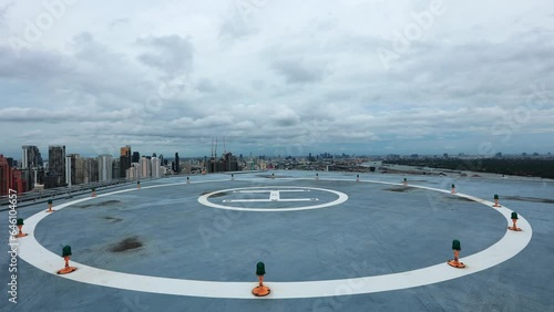 Time lapse of Helicopter landing   On the rooftop with rain clouds at Bangkok,Thailand. A rainstorm is brewing on the helicopter landing pad.