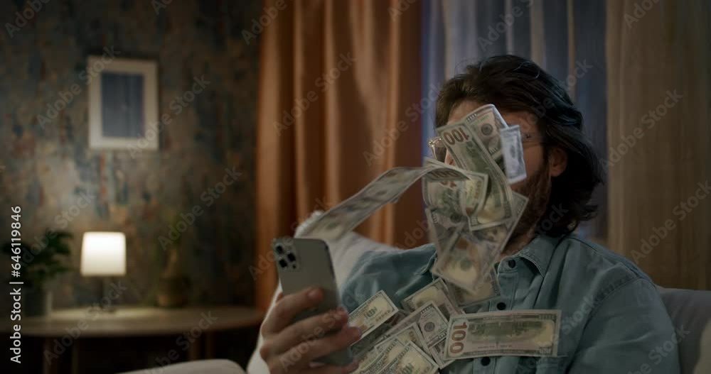 Cash flow, dollar bills floating in the man face. Online winning. Money rain flow through the smartphone. Man wins money online. Business making money online concept. Excited with banknote