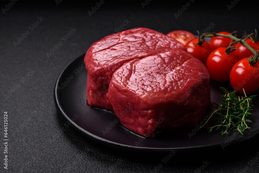 Raw fillet steak mignon beef with salt, spices and herbs Raw fillet steak mignon beef with salt, spices and herbs