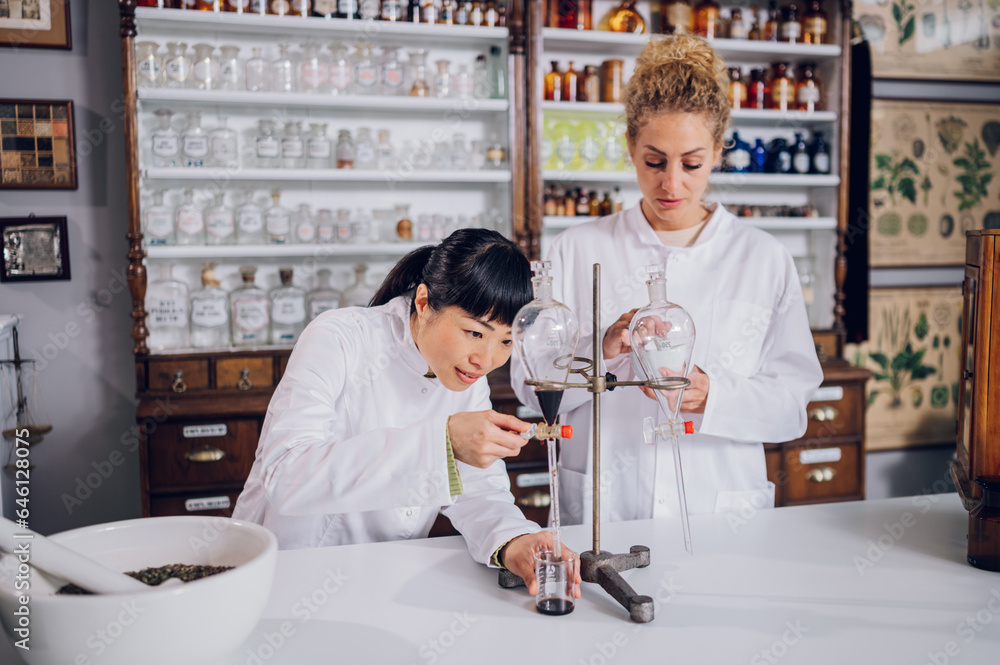 Japanese chemist is using a funnel for medicine making Stock Photo