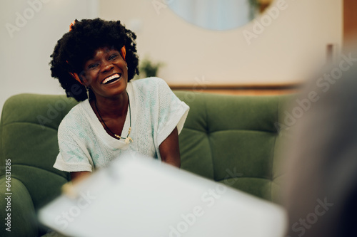 A cheerful african american woman is having a session with a psychotherapist