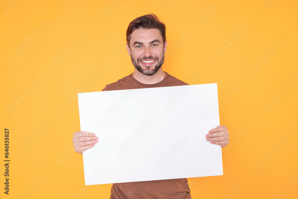 Blank signboard, billboard or banner with copy space. Happy attractive handsome smiling middle aged man showing promo blank board on studio background. Advertisement concept. Blank mockup. Blank signboard, billboard or banner with copy space. Happy attractive handsome smiling middle aged man showing promo blank board on studio background. Advertisement concept. Blank mockup.