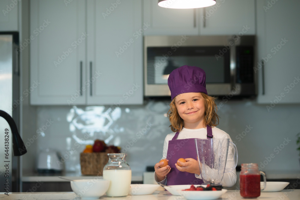 Kid chef cook wearing uniform cook cap and apron cooked food in the kitchen. Kid chef cook wearing uniform cook cap and apron cooked food in the kitchen.