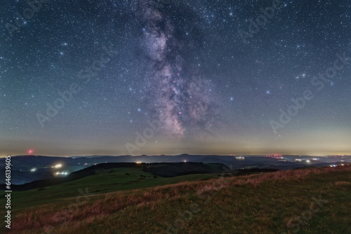 The Milky Way over the summit of the mountain Wasserkuppe in the Rhoen in Germany. photo