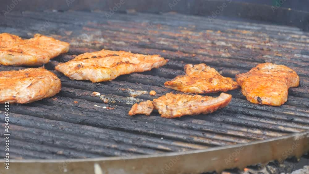 Pieces of chop meat being grilled and flipped, slow motion close-up view Pieces of chop meat being grilled and flipped, slow motion close-up view