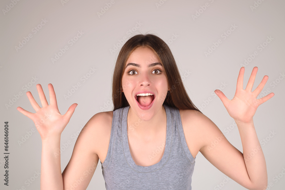 Emotional excited woman with amazed expression. Human reaction and emotions. Close up studio portrait of excited woman with facial expression. Emotional girl raising fists, celebrating success. Emotional excited woman with amazed expression. Human reaction and emotions. Close up studio portrait of excited woman with facial expression. Emotional girl raising fists, celebrating success.