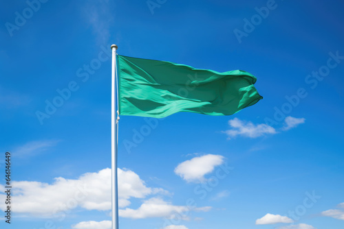 Wind-Kissed Green Banner Against a Heavenly Blue Backdrop