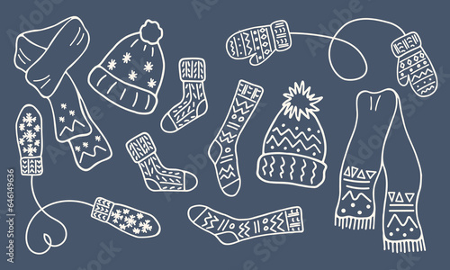 Warm knitted clothies set. Winter accessories collection in doodle style. White contour of Hats, mittens, socks, scarves.  Line hand drawn illustration