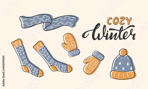 A set of cute knitted warm clothing elements. Winter woolen clothes. Cozy winter handwritten lettering. Hat, scarf, mittens, socks isolated on white. Doodle line yellow blue outerwear