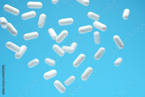 Bunch of pills suspended in mid-air. This versatile picture can be used to convey concepts related to healthcare, medicine, pharmaceuticals, addiction, or even alternative therapies.