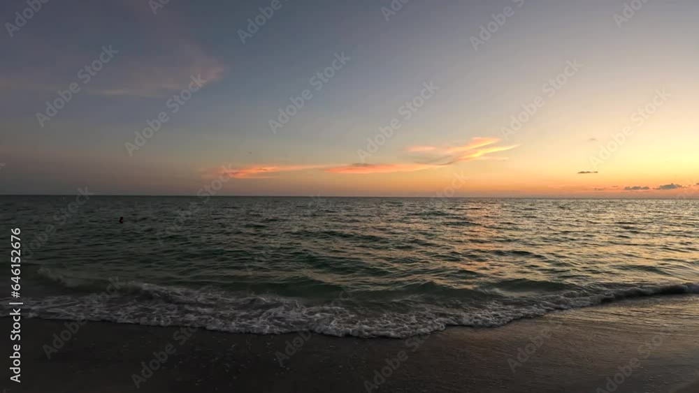 Golden hour beach pan around slow motion waves crash on beach Golden hour beach pan around slow motion waves crash on beach