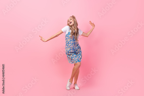 Full length portrait of overjoyed cheerful person partying dancing enjoy music isolated on pink color background