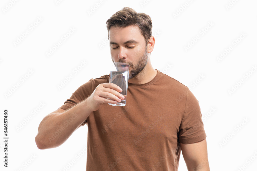 Man drinking fresh water. Male model holds glass of clear water. Healthy lifestyle, health care. Mineral water refreshment, daily dose of clean aqua, dehydration. Portrait of man drinking water. Man drinking fresh water. Male model holds glass of clear water. Healthy lifestyle, health care. Mineral water refreshment, daily dose of clean aqua, dehydration. Portrait of man drinking water.