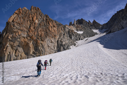 A group of climbers ascending to the pass Col Superieur du Tour, French Alps. Glacier Haute Route Chamonix - Zermatt. Alpinism and active tourism.