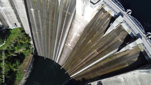 aerial footage of a huge dam next to and hidroelectric central photo