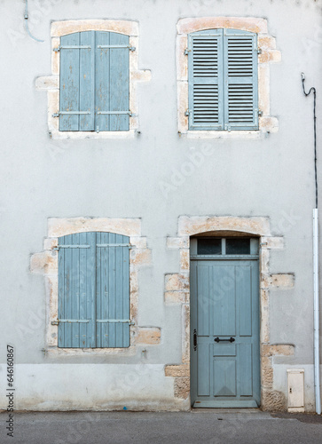 shutters and front door in facade of french village house © ahavelaar