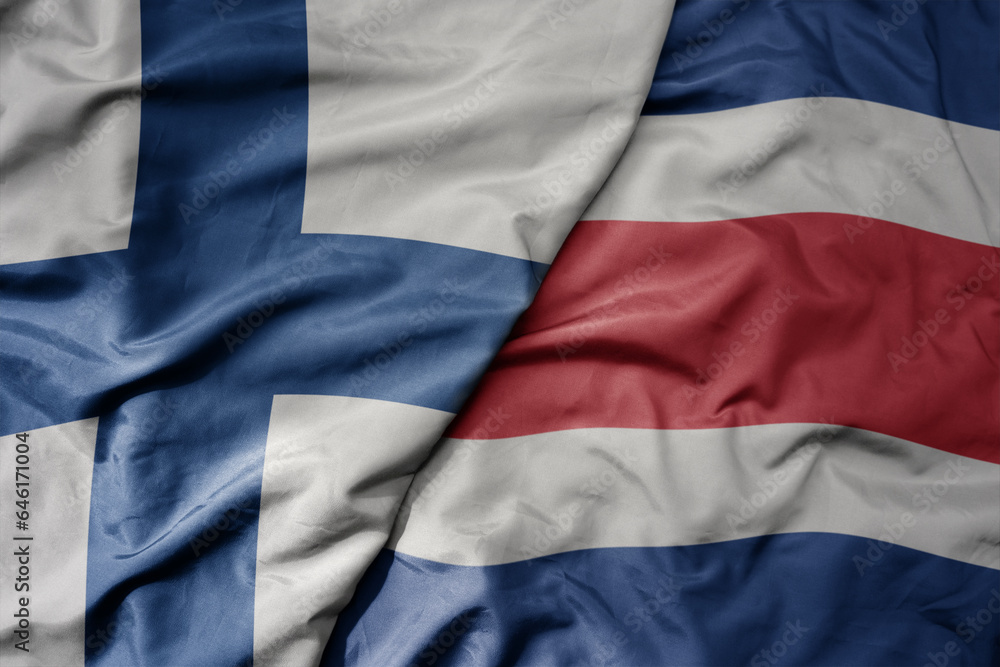 Obraz premium big waving national colorful flag of finland and national flag of costa rica .