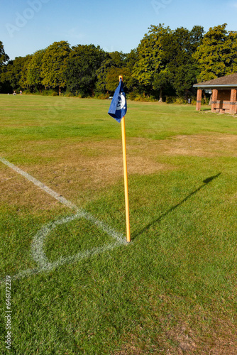 A corner flag and pitch markings at the corner of a football pitch in England, UK