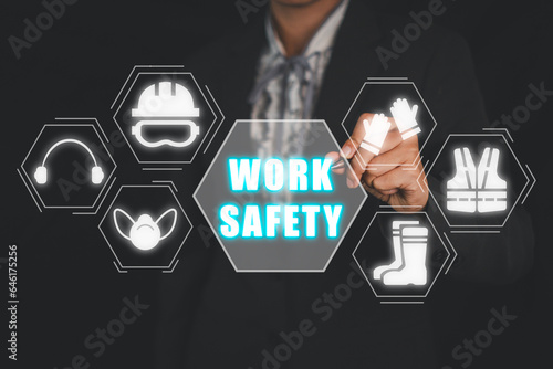 Work safety concept, Businesswoman hand touching work safety icon on virtual screen.