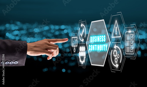 Business continuity concept, Businesswoman hand touching Business continuity icon on virtual sreen. photo