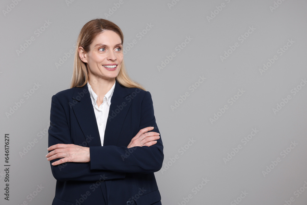 Happy real estate agent on grey background. Space for text Happy real estate agent on grey background. Space for text
