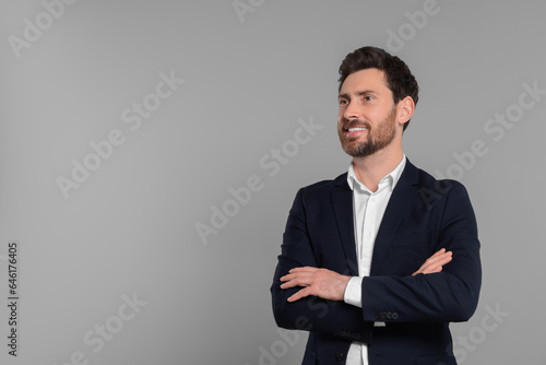 Happy real estate agent on grey background. Space for text