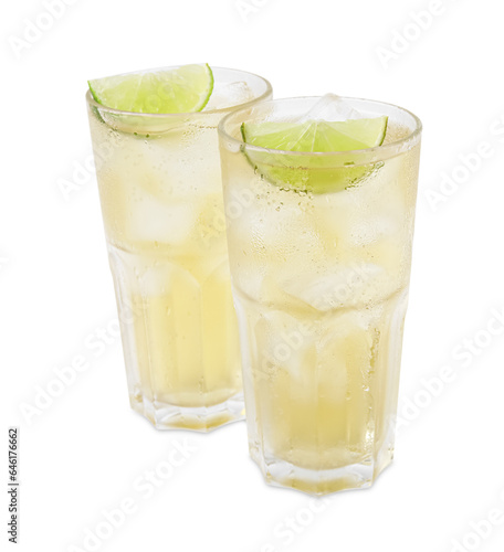 Glasses of tasty ginger ale with ice cubes and lime slices isolated on white