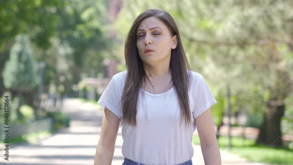 Woman with depressed mood is walking in the park. Woman with depressed mood is walking in the park.