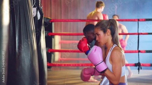 Asian beautiful athlete girl boxer doing workout in fitness stadium. photo