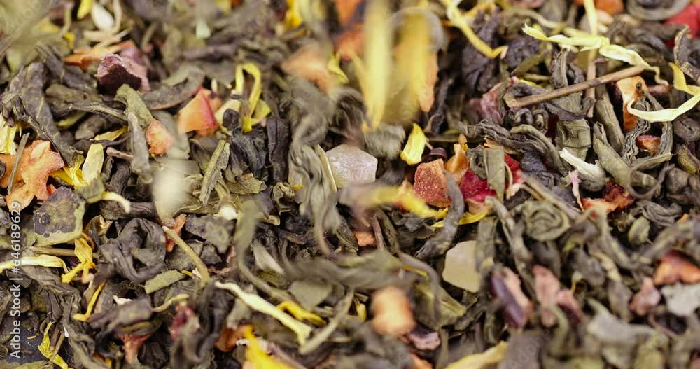 A large amount of dry green tea with pieces of fruit, delicious and fragrant green tea with a pleasant aroma A large amount of dry green tea with pieces of fruit, delicious and fragrant green tea with a pleasant aroma