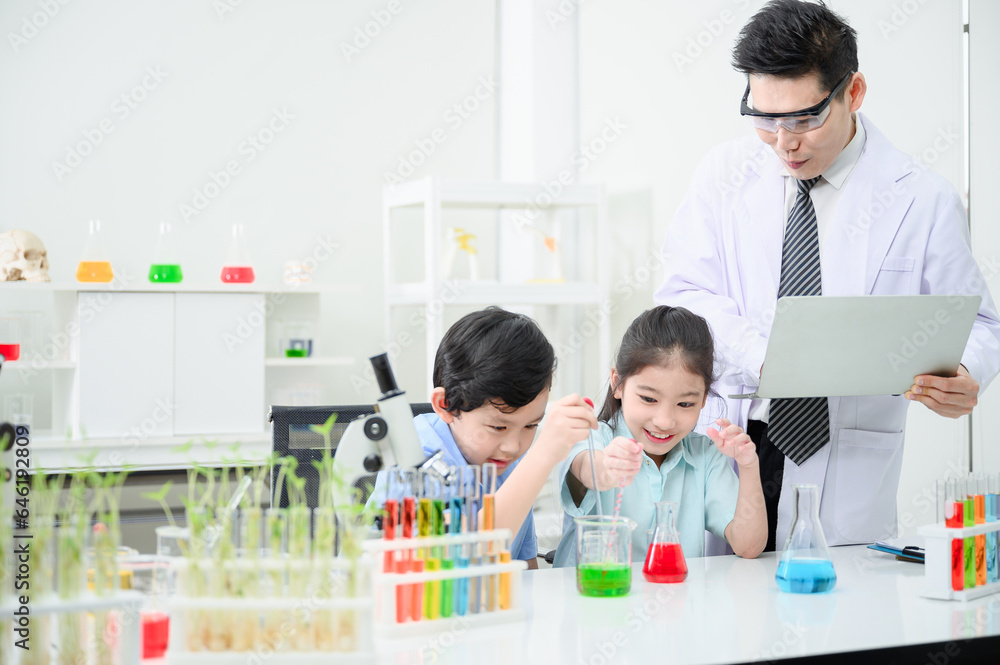 Fototapeta premium Male and female students and teachers work together to study test tubes in the studio. Study with fun