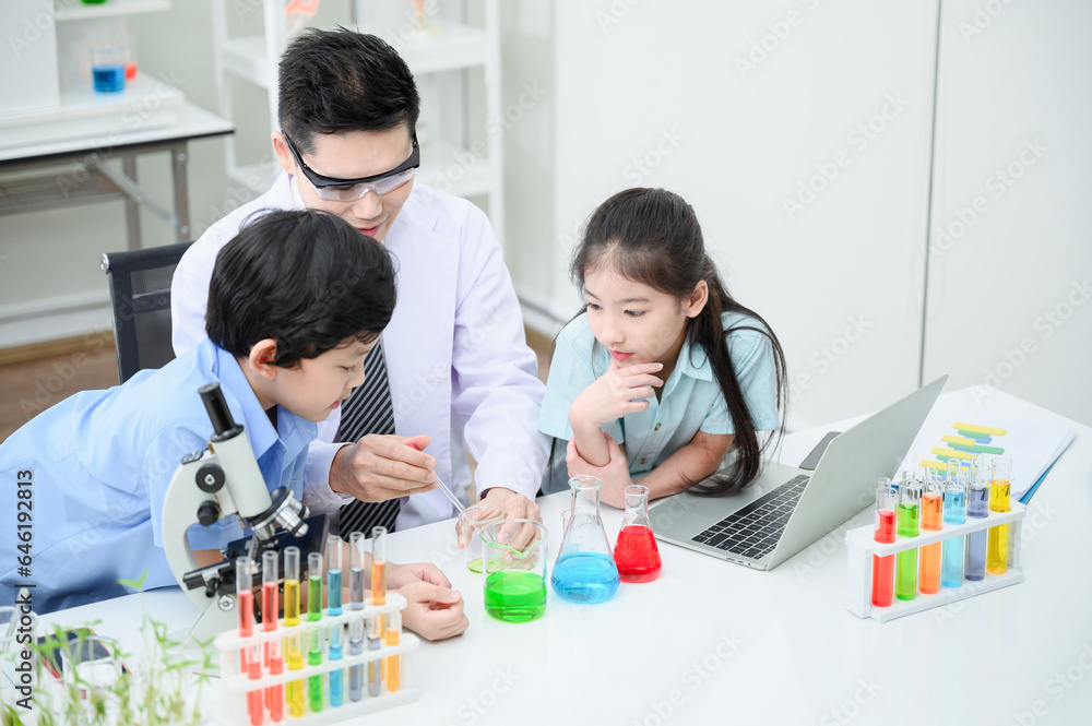 Male and female students and teachers work together to study test tubes in the studio. Study with fun Male and female students and teachers work together to study test tubes in the studio. Study with fun