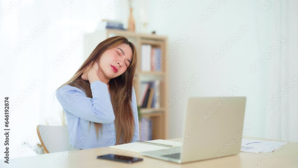 Office syndrome concept. Young asian woman feeling pain in neck and shoulder after working on computer laptop for a long time. She stretches to relax her muscles Office syndrome concept. Young asian woman feeling pain in neck and shoulder after working on computer laptop for a long time. She stretches to relax her muscles
