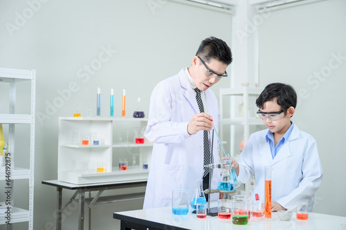 The teacher is teaching the boy in the learning and studying laboratory.