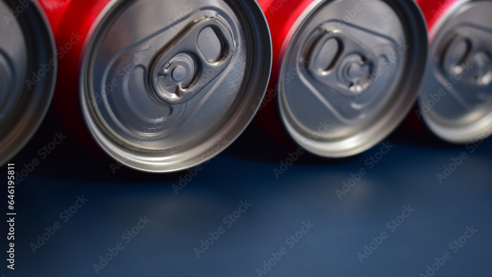 close up group of aluminium red cans soft drink put on blue texture background close up group of aluminium red cans soft drink put on blue texture background