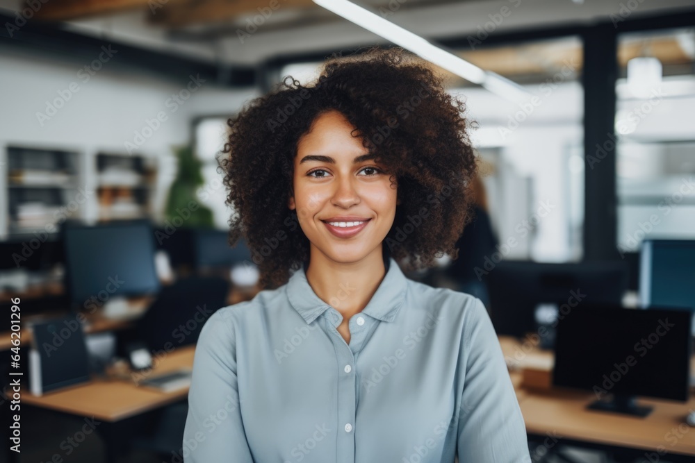 Smiling portrait of a happy young african american businesswoman working in a startup company office Smiling portrait of a happy young african american businesswoman working in a startup company office