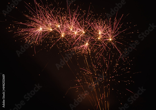 multiple bright pink fireworks at night