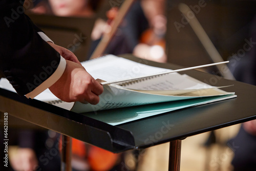 Photography Close-up of conductor's hands turning over sheet music
