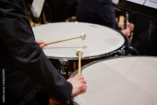 Obraz na plátně Close up of male hands playing drums at concert