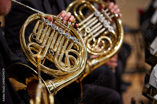 Close up of performer's hands playing horn
