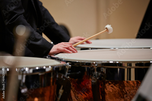 Close up of male hands playing drums at concert