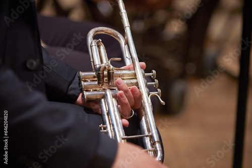 Close-up of a musician's hands playing the trumpet