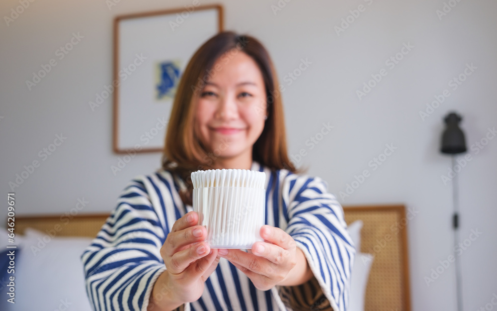 Portrait image of a woman holding a cotton buds at home Portrait image of a woman holding a cotton buds at home