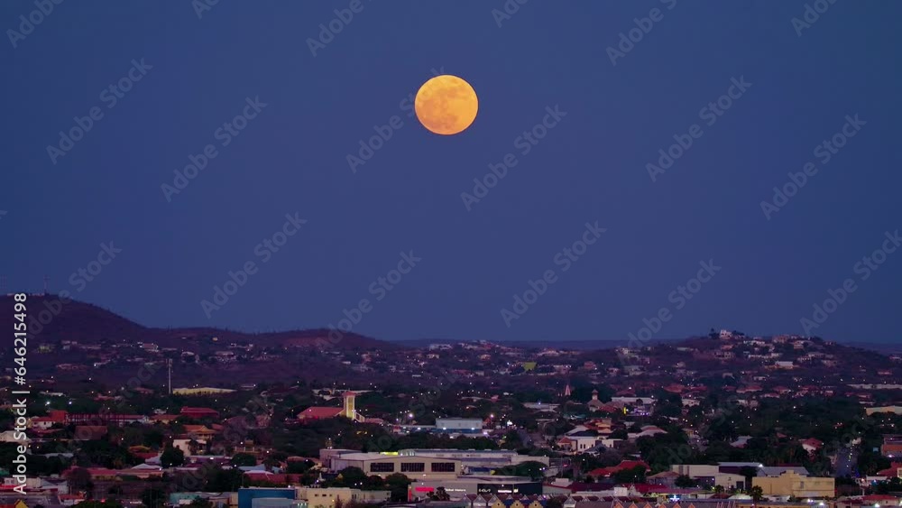 Supermoon sits magnificent in sky, red orange tint above willemstad curacao Supermoon sits magnificent in sky, red orange tint above willemstad curacao