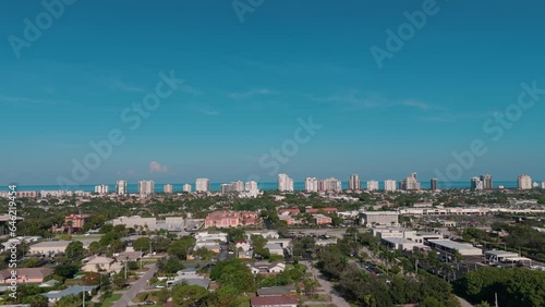 Wide Drone shot of the bay and buildings in the city of Naples, Florida on day time photo