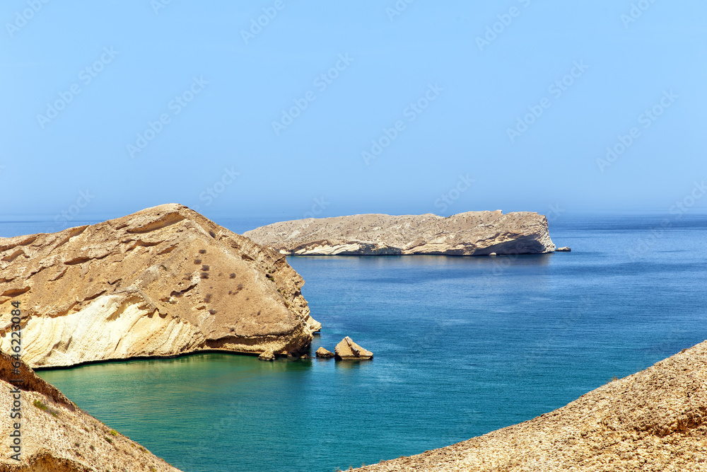 Lifeless rocky islands under the scorching sun off the coast of Oman in the Gulf of Oman